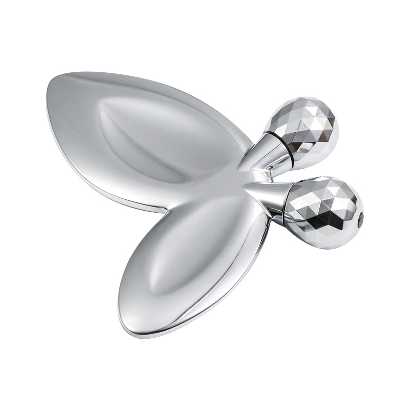 Sinkkiseoksesta valmistettu perhosen muotoinen kasvohierontarulla Sinkkiseoksesta valmistettu perhosen muotoinen kasvohierontarulla